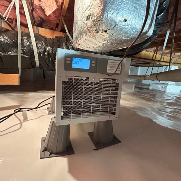 Crawl space dehumidifier working in a sealed Ocala, FL crawl space, maintaining dry air and protecting the foundation.