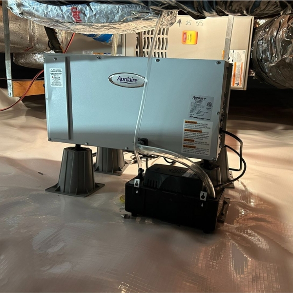 A fully installed crawl space dehumidifier inside a sealed crawl space in Jacksonville, FL, part of the encapsulation system.