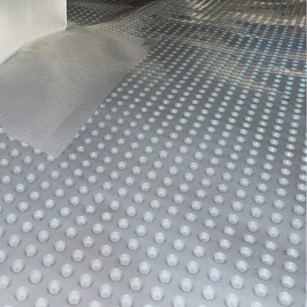 Durable crawl space drainage matting installed in a Palm Coast, F,L to channel moisture toward drainage lines.