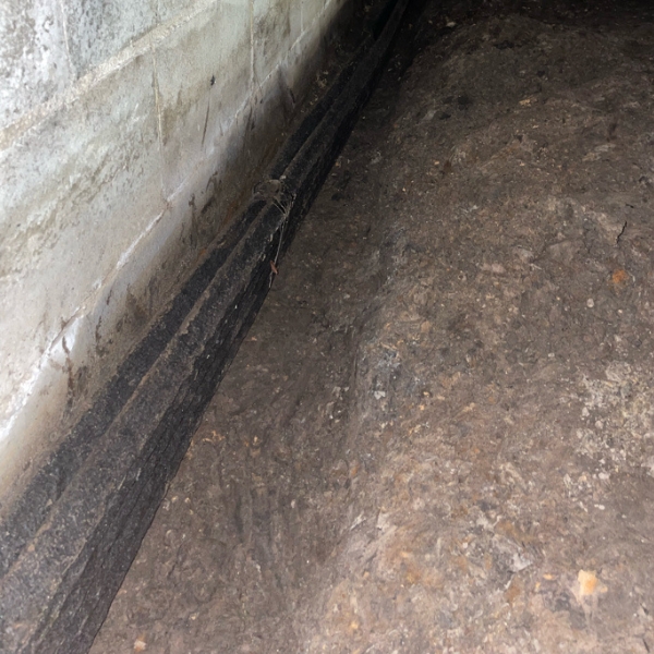 Crawl space perimeter French drain installed in a Gainesville, FL, capturing groundwater and directing it to the sump pump system.