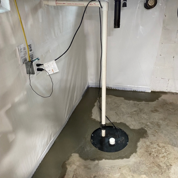 Basement sump pump system installed in Jacksonville, FL, collecting water and keeping the lower level safe and dry.