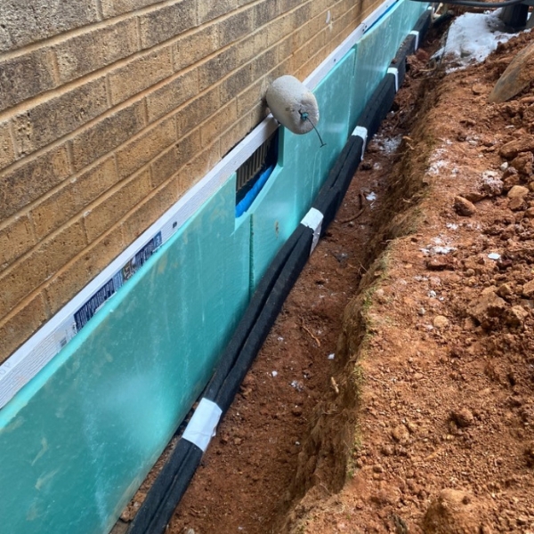 Finished exterior foundation waterproofing installation in Gainesville, FL, protecting the home from water damage.