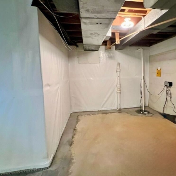 Interior foundation waterproofing installation in Gainesville, FL, showing sealed cracks and a drainage channel for moisture control.