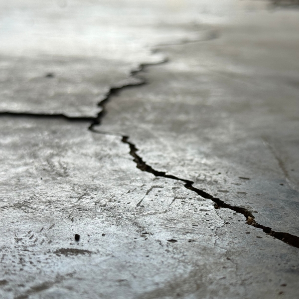 Basement floor crack caused by soil washout and uneven foundation support, needing basement floor crack repair in Northern Florida.