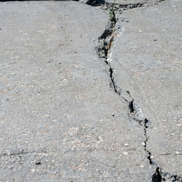 Concrete slab with chipped concrete due to erosion and structural movement underneath, needing chip concrete repair in Florida.