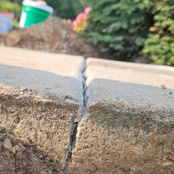Damaged concrete with visible cracks showing common causes of concrete deterioration, needing concrete caulking in Ocala, FL.