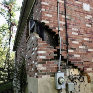 Huge foundation cracks due to foundation settlement, causing cracks in concrete walls in Palm Coast, FL.
