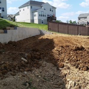 Home with soil sloping toward the foundation, a common cause of wet crawl space issues in Gainesville, FL.
