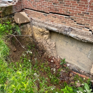 Soil erosion in the concrete slab leading to floor cracking and dipping, causes of uneven floor in Middleburg, FL.