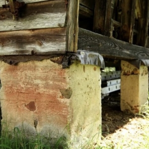 A leaning foundation due to structural overloading, causing cracks in concrete walls in Lake City, FL.