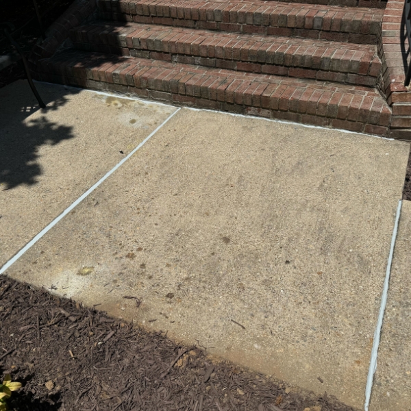 Finished sidewalk concrete caulking in Jacksonville, FL, sealing cracks and protecting the surface from damage.