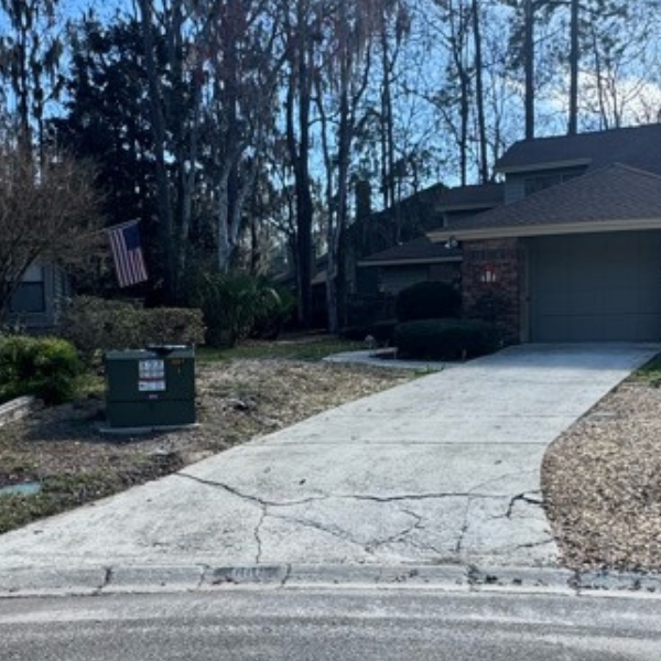 Cracked concrete driveway in Ocala, FL, showing visible surface damage from Florida’s sandy soils and heavy rainfall conditions.