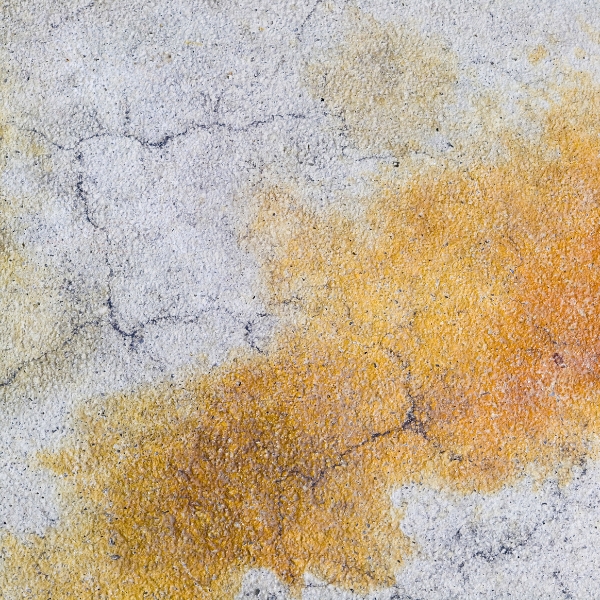 Concrete slab with cracks and a stained surface caused by humidity and salt exposure, needing concrete sealing in Ocala, FL.