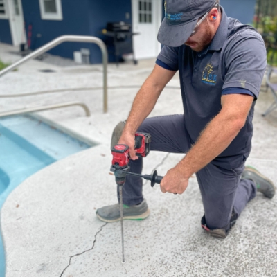 Expert sealing of small pool deck cracks with flexible concrete caulking, a pool deck crack repair solution in Fernandina Beach, FL.
