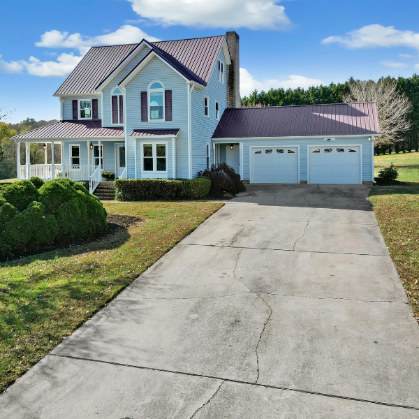 Close-up of cracked concrete driveway and parking lot surface caused by soil erosion and water damage, needing driveway crack repair in Northern Florida.
