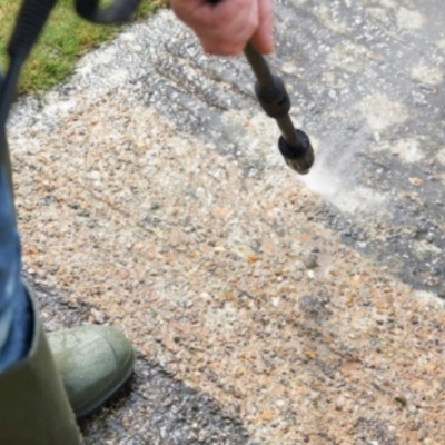 Expert applying moisture-resistant sealant to concrete surface, a garage floor crack repair solution in Crescent City, FL.
