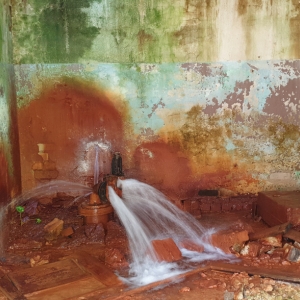 A damaged plumbing pipe bursting, causing water leaks and wet crawl space insulation in Ocala, FL.