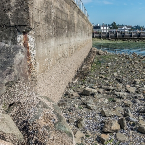 Washed-out soil behind seawall panels showing settlement voids causing seawall cracks in Middleburg, FL.