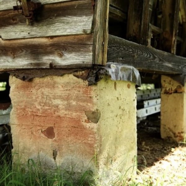 Settling concrete pier failing to support a home structure, showing overloaded soil loses support, needing an exceed support capacity solution in Jacksonville, FL.