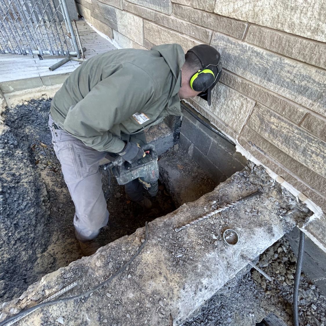 An expert preparing a foundation for push pier installation to fix settling issues caused by foundation problems in Northern Florida.