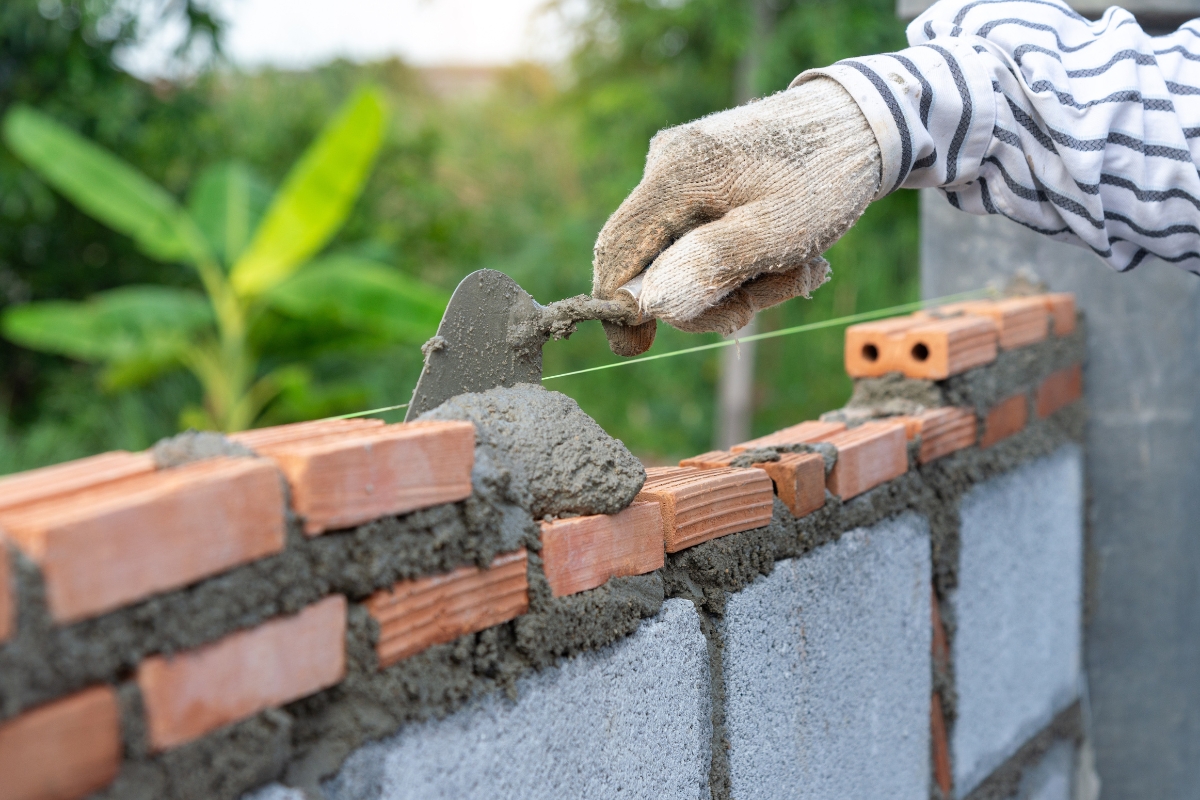 Uneven bricklaying and sloppy mortar work from poor construction practices, shown as a cause of foundation issues in Gainesville, FL.