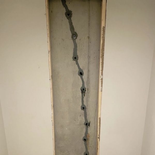 Repaired vertical crack in an exposed foundation wall, a slope failure repair in Crescent City, FL.