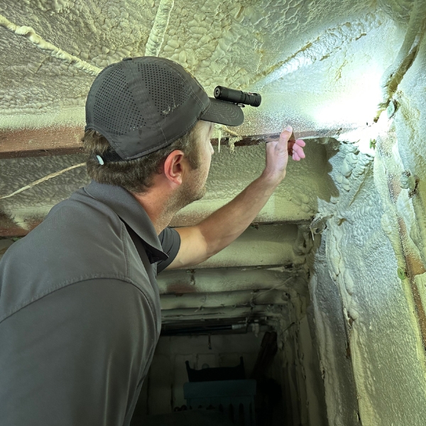 Specialist inspecting deteriorating concrete and weak foundation materials for water damage in Middleburg, FL.