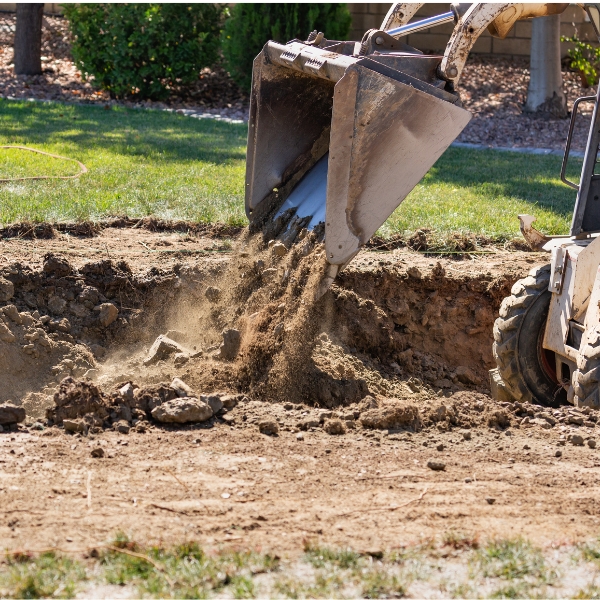 Soil regraded to slope away from a home, preventing pooling water, a foundation drainage solution in Lake City, FL.