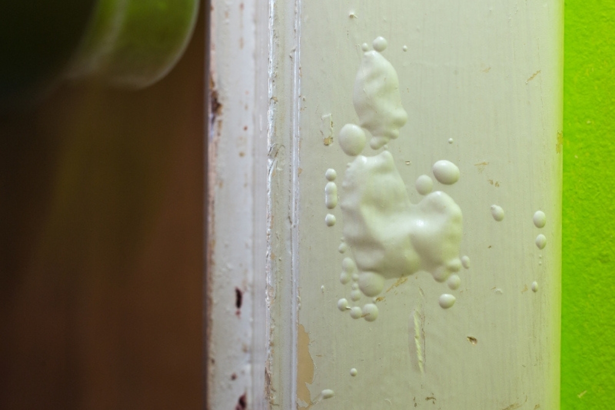 Bubbling drywall caused by forcing moisture behind the interior wall surface; a sign of excessive rainfall damage in Ocala, FL.