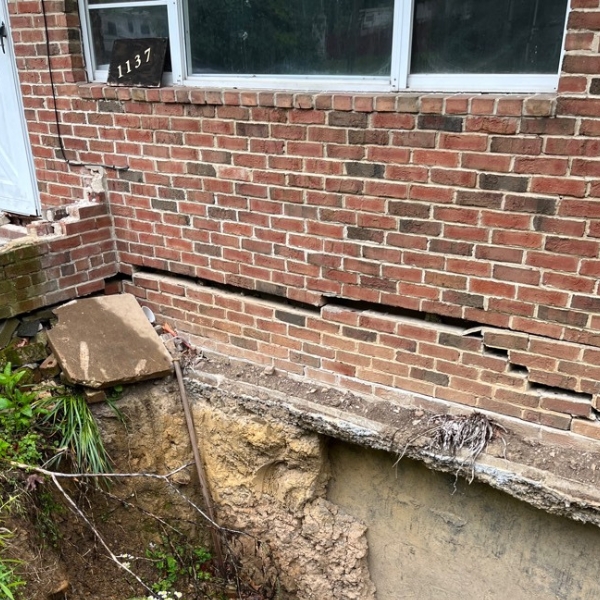 Exposed loose soil sinking beneath a Florida home foundation, needing a poor compaction solution in Jacksonville, FL.
