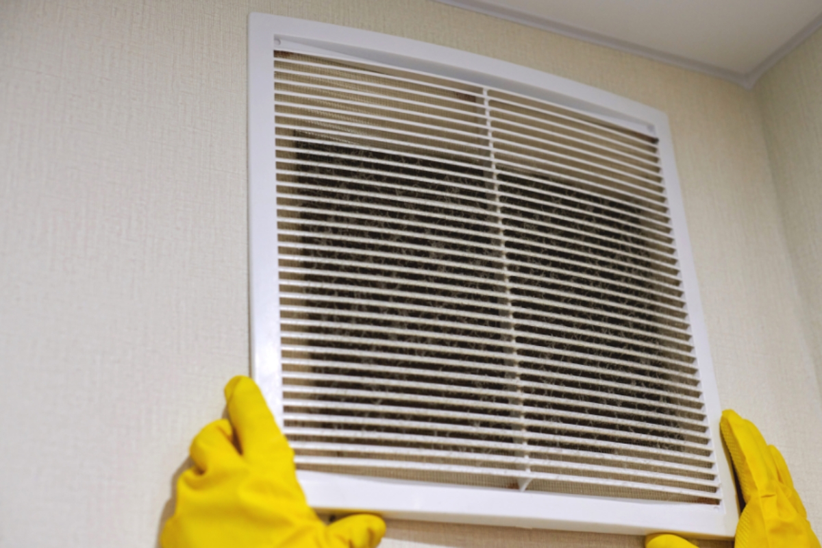 Dirty vent cover showing restricted airflow and poor ventilation contributing to basement condensation in Gainesville, FL.