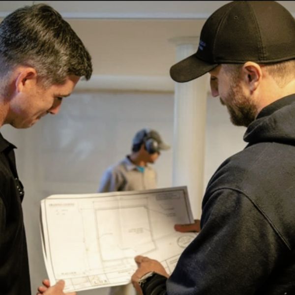 Contractors reviewing plans to prevent foundation damage, a poor construction foundation solution in Jacksonville, FL.