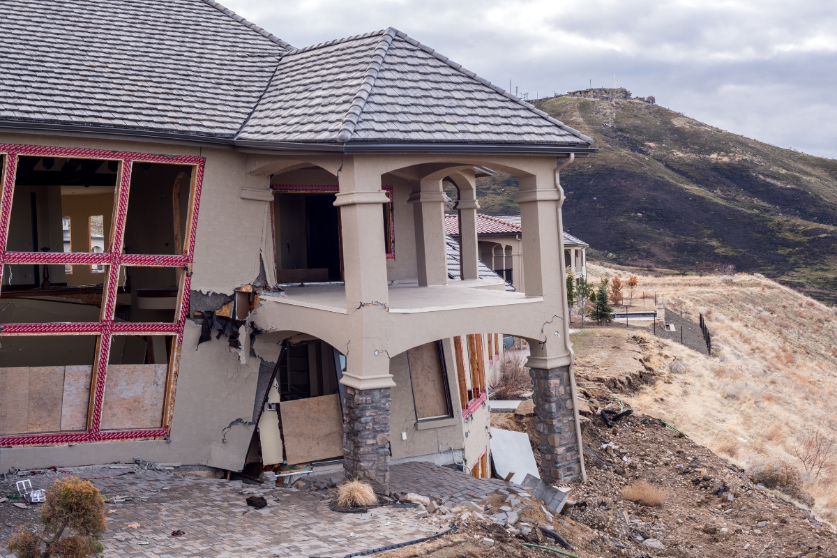 Severely damaged home on collapsing ground showing sinkhole activity cause of foundation failure in Ocala, FL.