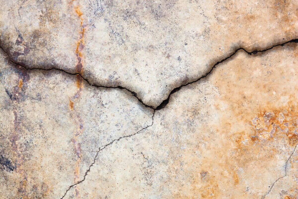 Older concrete slab cracking under the pressure of heavy vehicles and equipment, causes of concrete heavy load damage in Palm Coast, FL.