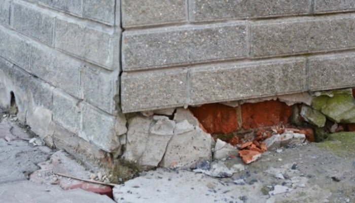 Chipping concrete along a foundation surface, indicating surface deterioration, a sign of a foundation problem in Palm Coast.