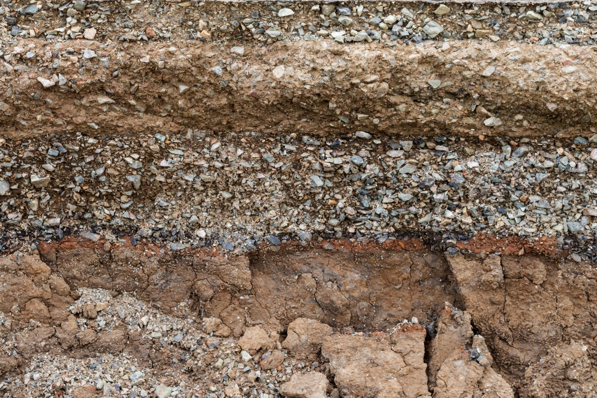 Exposed layers of clay and sandy soil showing pockets that can swell and shift a home’s crawl space in Palm Coast, Florida.