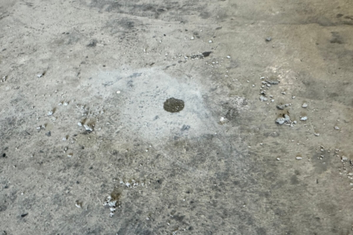 Concrete surface chipping after harsh cleaners and pressure washing, causes of concrete chemical damage in Ocala, FL.