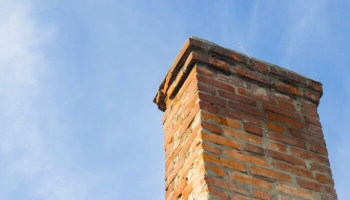 Cracked chimney bricks due to shifting foundation support, a sign of a foundation problem in Palm Coast.