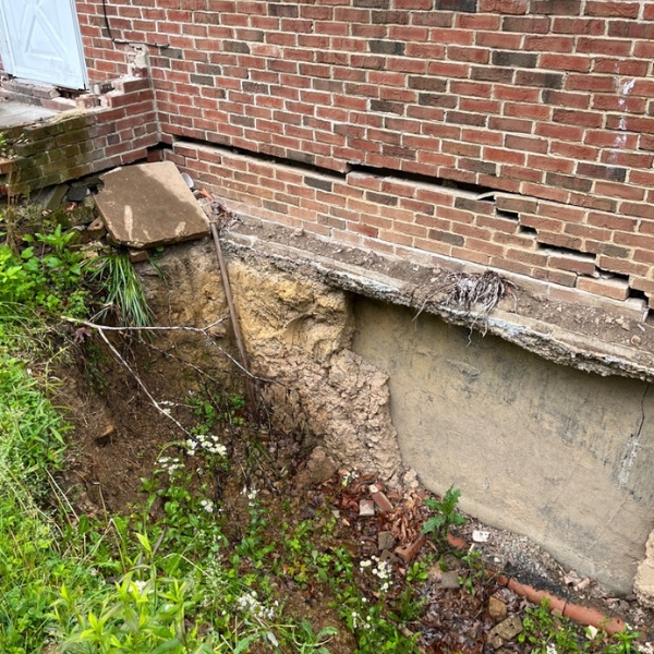 Soil erosion at a home’s foundation causing damage due to expansive soil, which needs crawl space repair in Jacksonville, Florida.