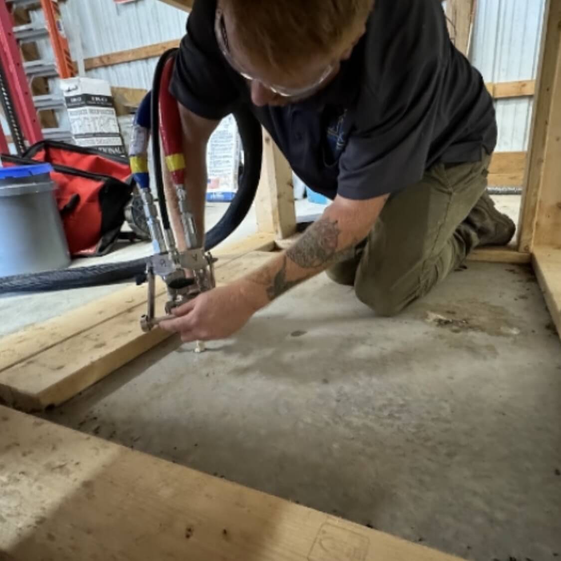 LUX technician lifting an uneven concrete slab during a professional concrete repair in Northern Florida.