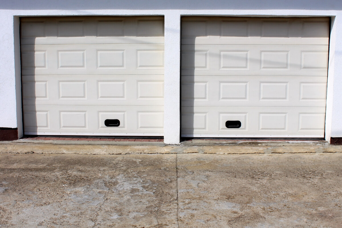 Driveway concrete pitting and discoloration caused by fertilizer, causes of concrete chemical damage in Gainesville, FL.