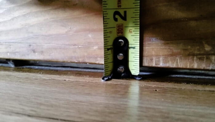 Gap forming between floor and wall inside a home, a sign of a foundation problem in Palm Coast.