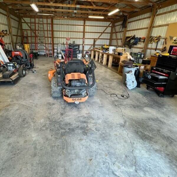 Concrete slab sinking under heavy vehicle weight, soil and moisture changes, needing concrete repair in Jacksonville, FL.