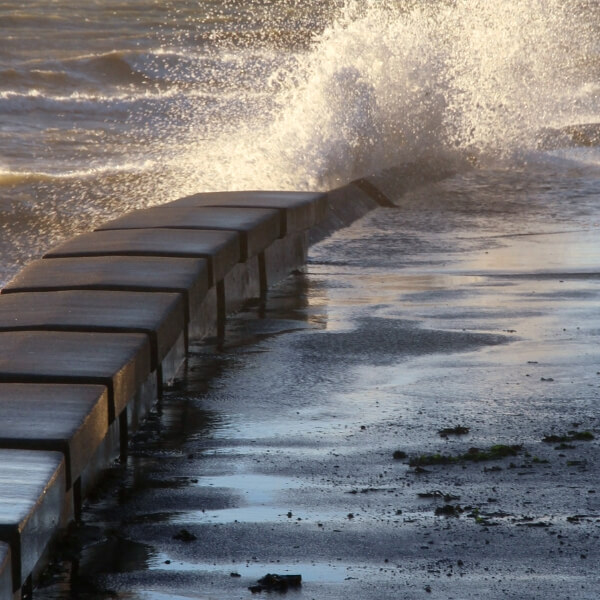 Saturated soil pressing hard against a seawall, showing how hydrostatic pressure needs seawall damage repair in Jacksonville, FL.