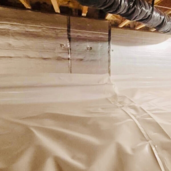 Moisture-resistant insulation boards installed above a dirt crawl space to protect floors in Crescent City, FL.