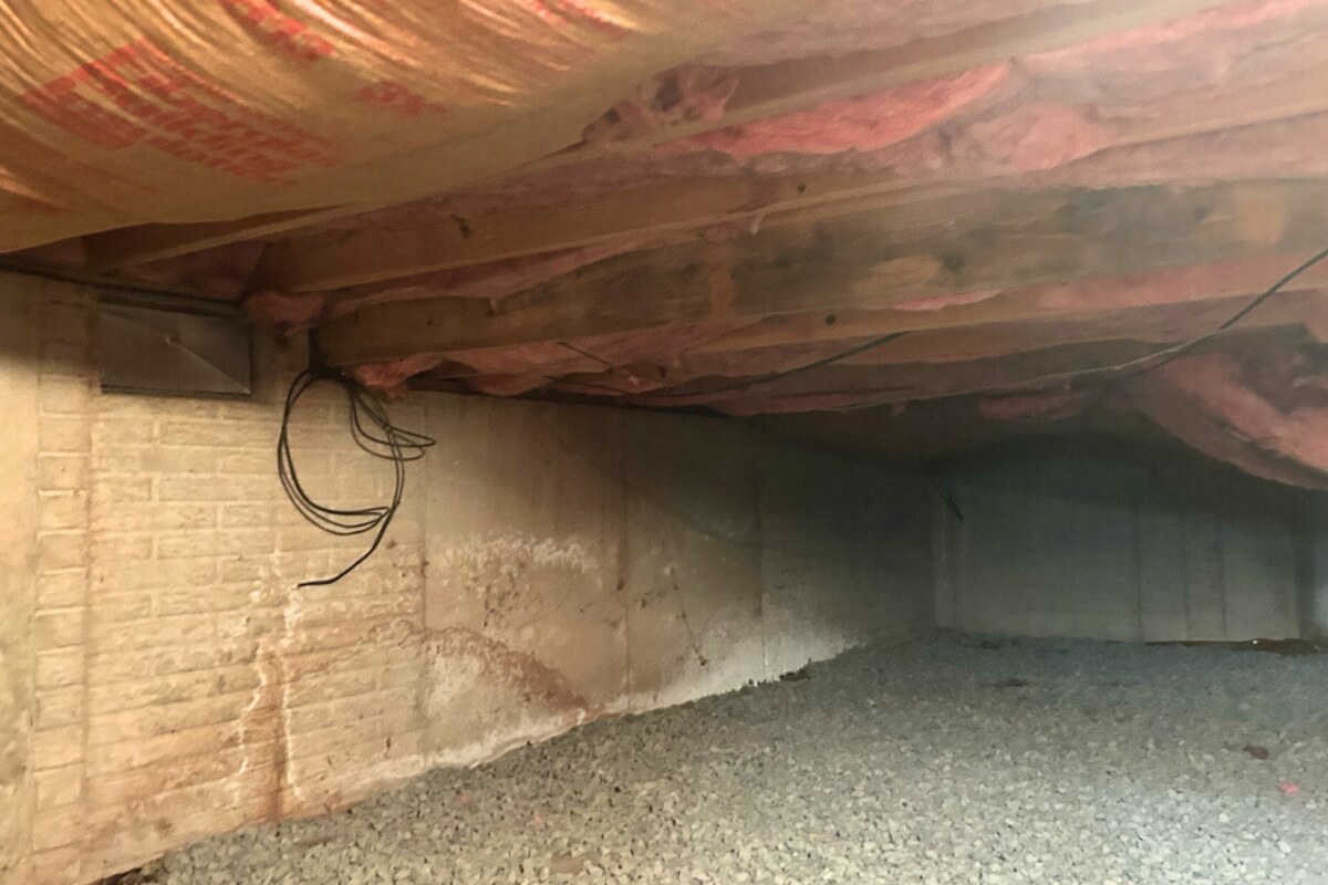 Exposed dirt crawl space floor releasing moisture, causing insulation to fall in the crawl space in Fort Lauderdale, FL.