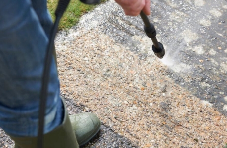 Technician applying concrete sealer in St. Augustine, FL, outdoor slab to protect the surface from moisture and weather damage.
