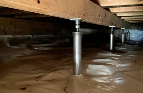 Installed crawl space support posts in a St. Augustine, FL home, reinforcing floor stability and structural support beneath the house.