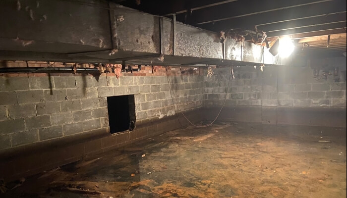 Flooded crawl space in Ocala, FL, indicating drainage challenges and a sign of crawl space problems.