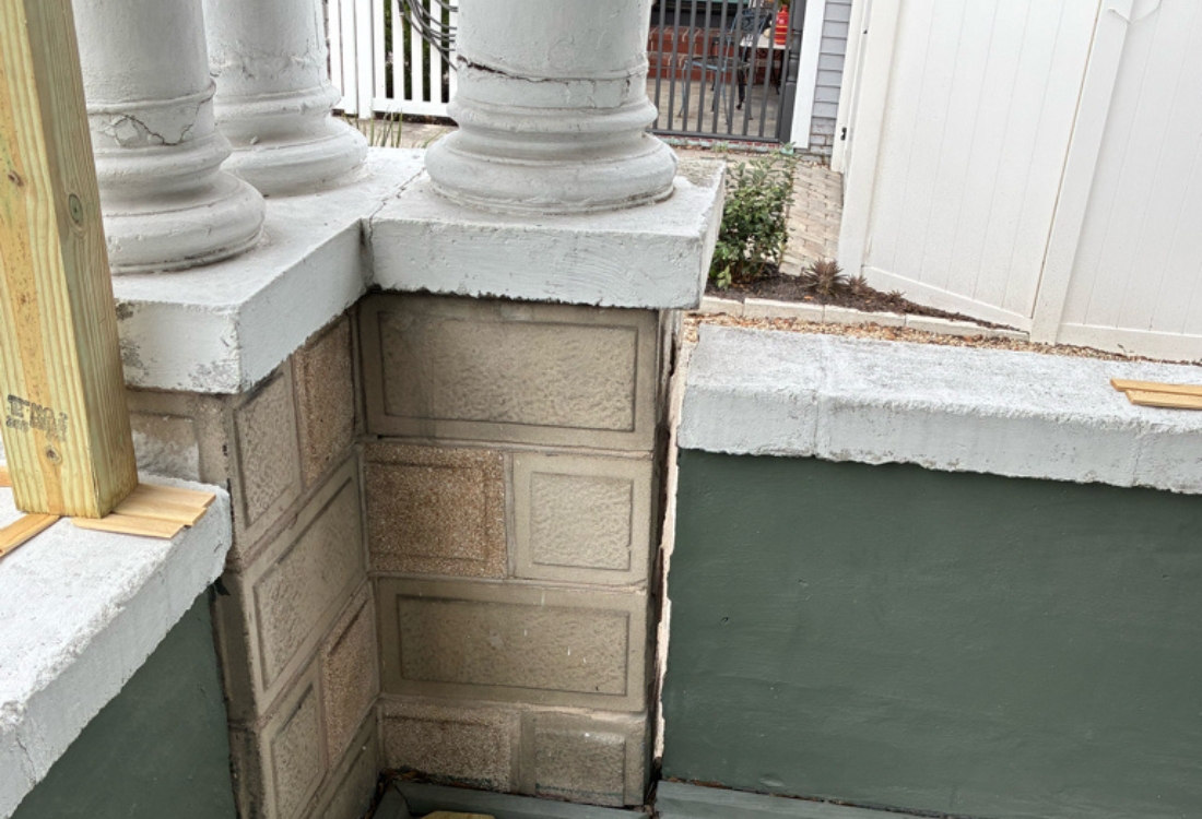 Settling historic concrete front porch with column separation and cracked masonry foundation wall in St. Augustine, FL.